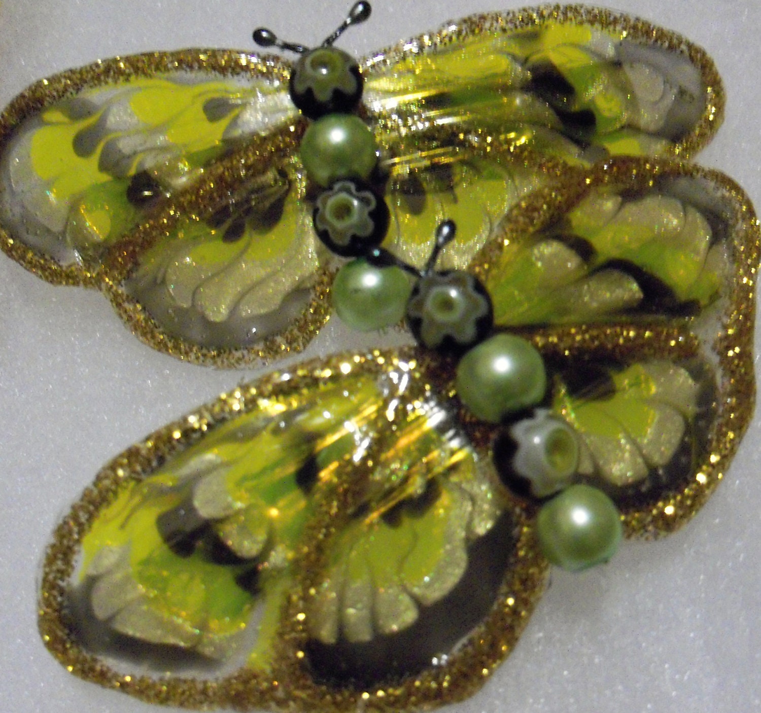 pair of small green butterfly barrettes