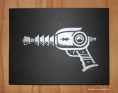 Shiny Silver Ray Gun silk screen print on sparkly black paper