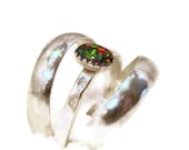 Brilliant opal ring flanked by low domed bands R109