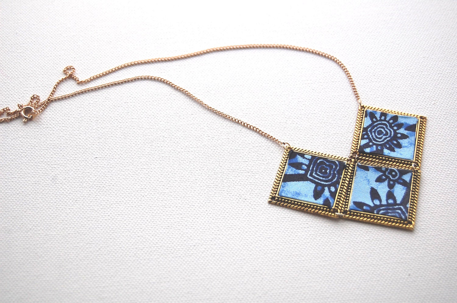The Cleo Necklace - blue African print fabric, gold plated chain
