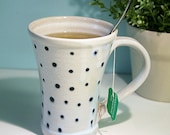 White porcelain mug with polka dot pattern.