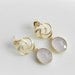 Gold and milky pink faceted gemstone earrings.