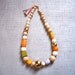 Cadoro Necklace/ Wood, Golden foiled beads, Vibrant, designer necklace, Tassel