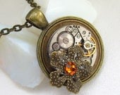 Steampunk Gothic   flower necklace - with small vintage watch movement., brass flower and real Swarovski crystal. Gift under 35 Dollars