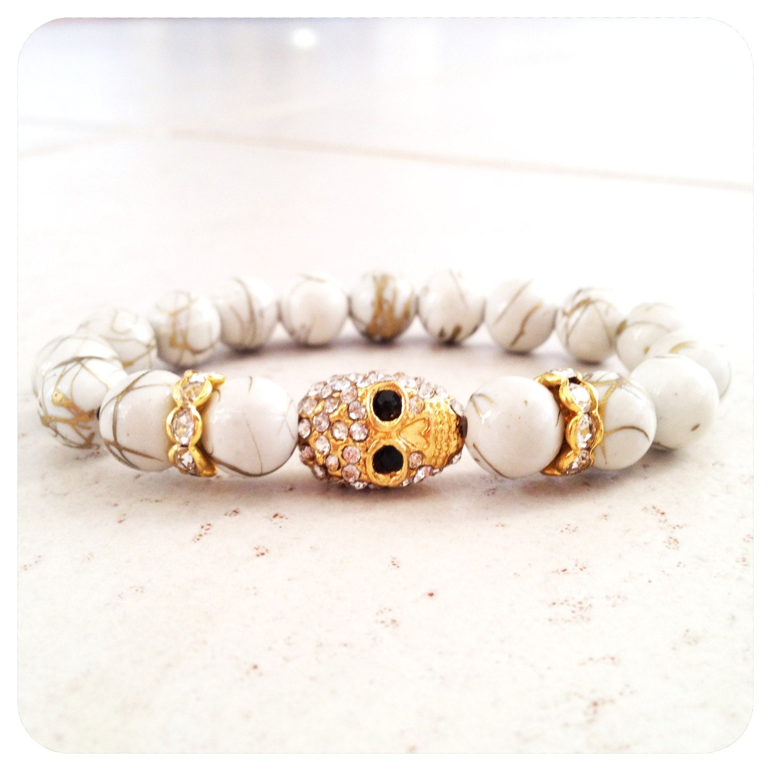Gold Drizzled White Bead Bracelet with Crystal Skull Charm and Rondelles