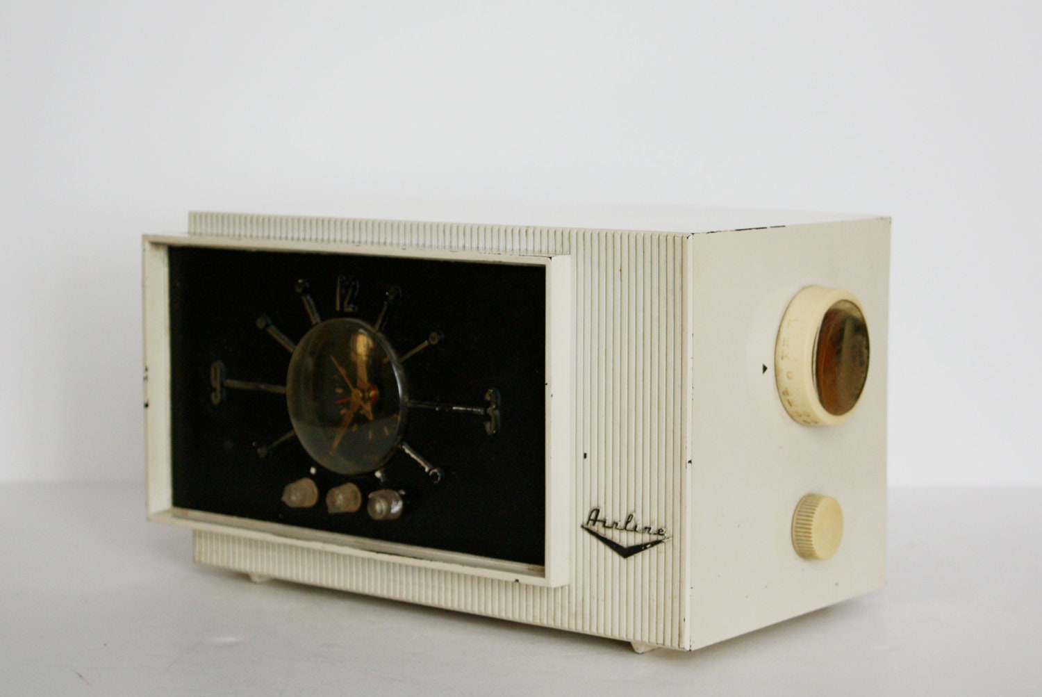 Vintage clock radio.  White mid century airline clock radio/AM radio.