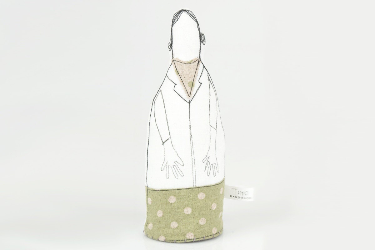 Mother, aunt, friend or grandmother you probably know this woman. Handmade cloth doll wearing spotted  green canvas