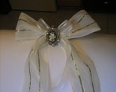 Cream and Gold Ribbon with a Black and Cream Flower Metal Broach Center Piece