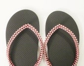 Custom made decorated flip flops. Designed black and pink rubber sandals.
