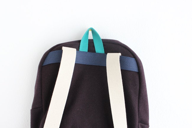 Dark brown wool backpack with dark teal pouch.