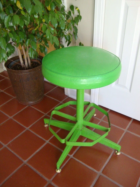 large vintage rotating work stool with cushion seat and heavy metal base