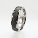 Meteorite inlaid in a Platinum Ring with a wavy profile.