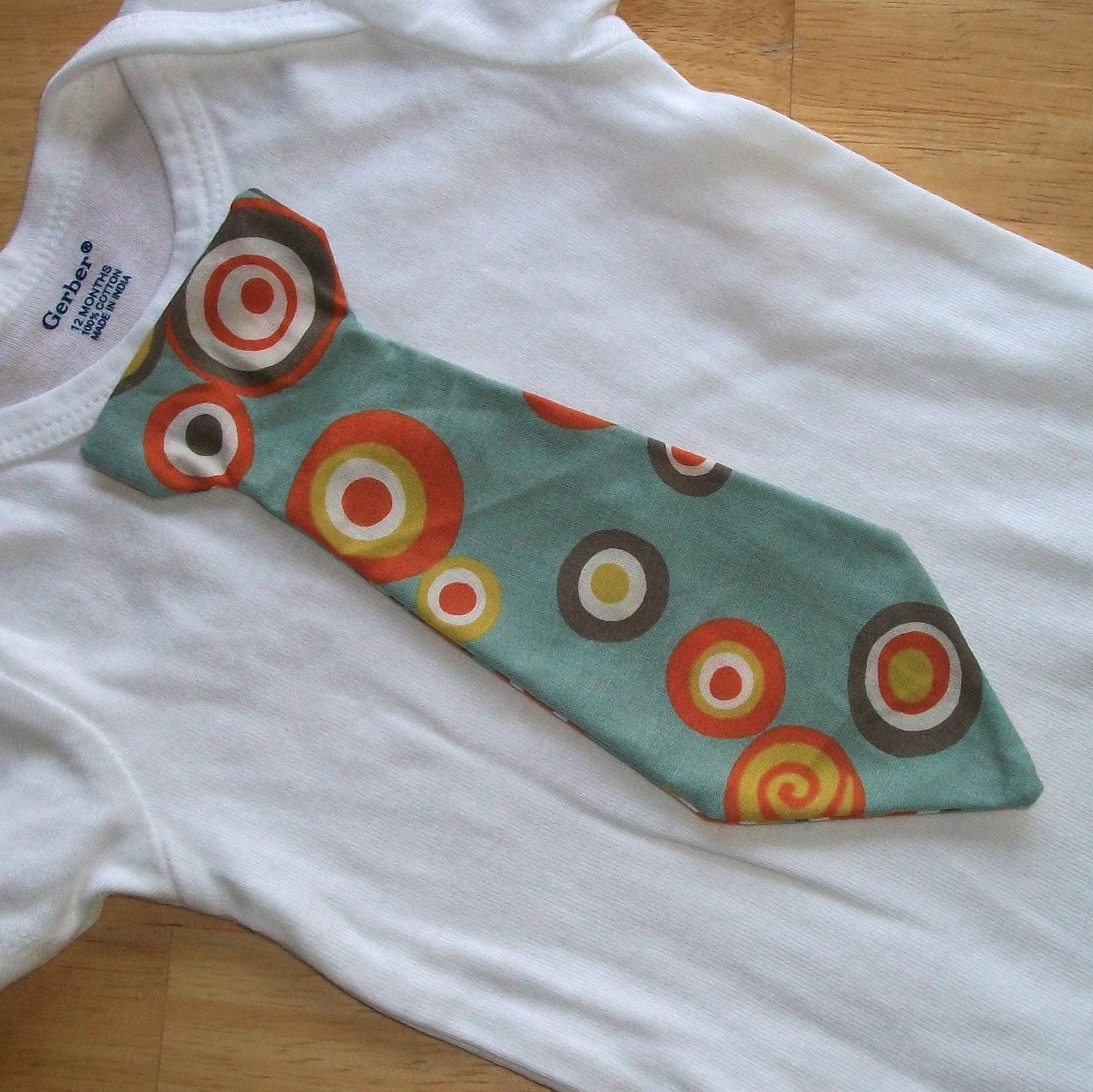 Last one...Baby tie onesie or shirt with blue gray, orange and yelllow circles...last one for Easter