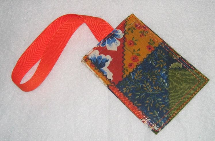 Crazy quilt luggage tag with orange strap
