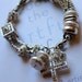 multi strand braclet, cross bracelet, pearl bracelet, wedding bracelet, pandora bracelet, chamr bracelet.....Which Way is Up