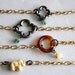 Arm Candy - small black quatrefoil clover flower with sea green bead charm gold chain bracele - gifts under 15