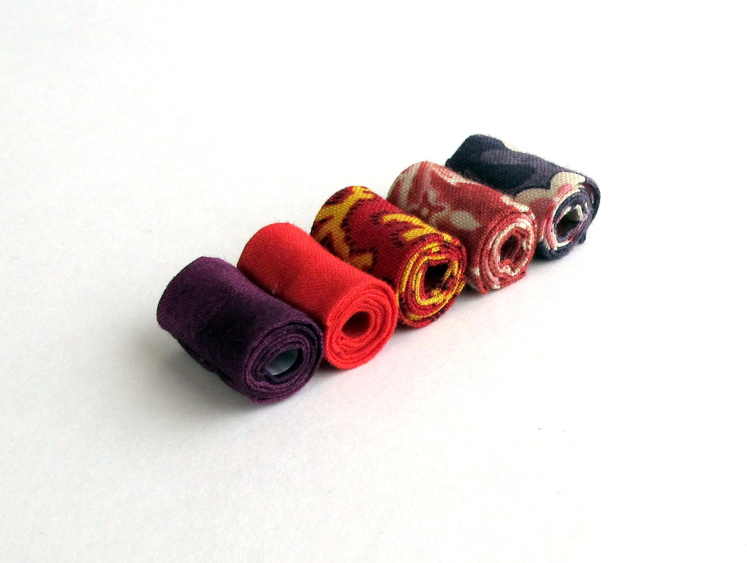 Hand rolled artisan fiber beads in fire printed cotton