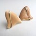 Peach pearlized wavy triangle post earrings, 1980s