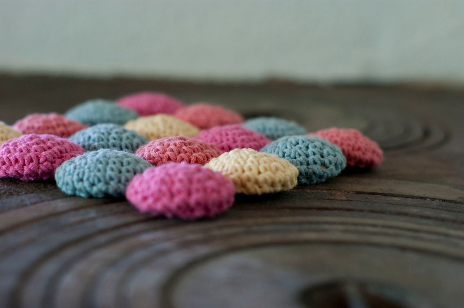 Eco cotton and wood trivet in pastels. Crocheted circles in pink, peach, yellow and blue. Eco friendly.