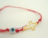 bracelet gold cross  jewelry with evil  eye on a red rope closes with turquoise stone