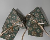Green and gold pyramid gift box set with holiday prints.
