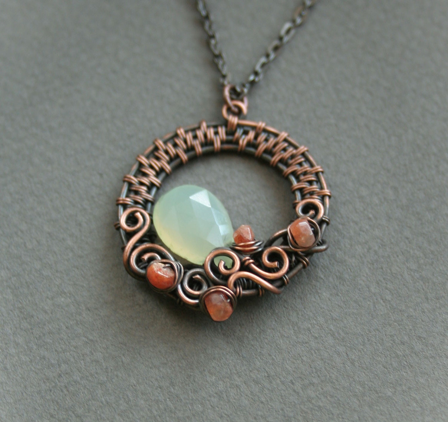 Swirls - copper wire woven pendant with green calcedony and sunstone beads
