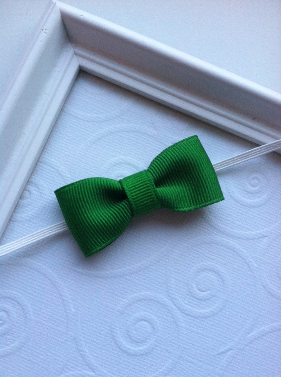 Green Mini Tuxedo Bow attached to a White Skinny Elastic Headband