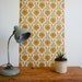 1970's french wallpaper with geometric flower design in greens, browns and orange, full roll