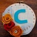 Monogram Initial Embroidery Hoop Art 5-Inch with Felt Flowers and Leaves Peacock, Red, Marigold and Goldenrod Handstitched by Catshy Crafts