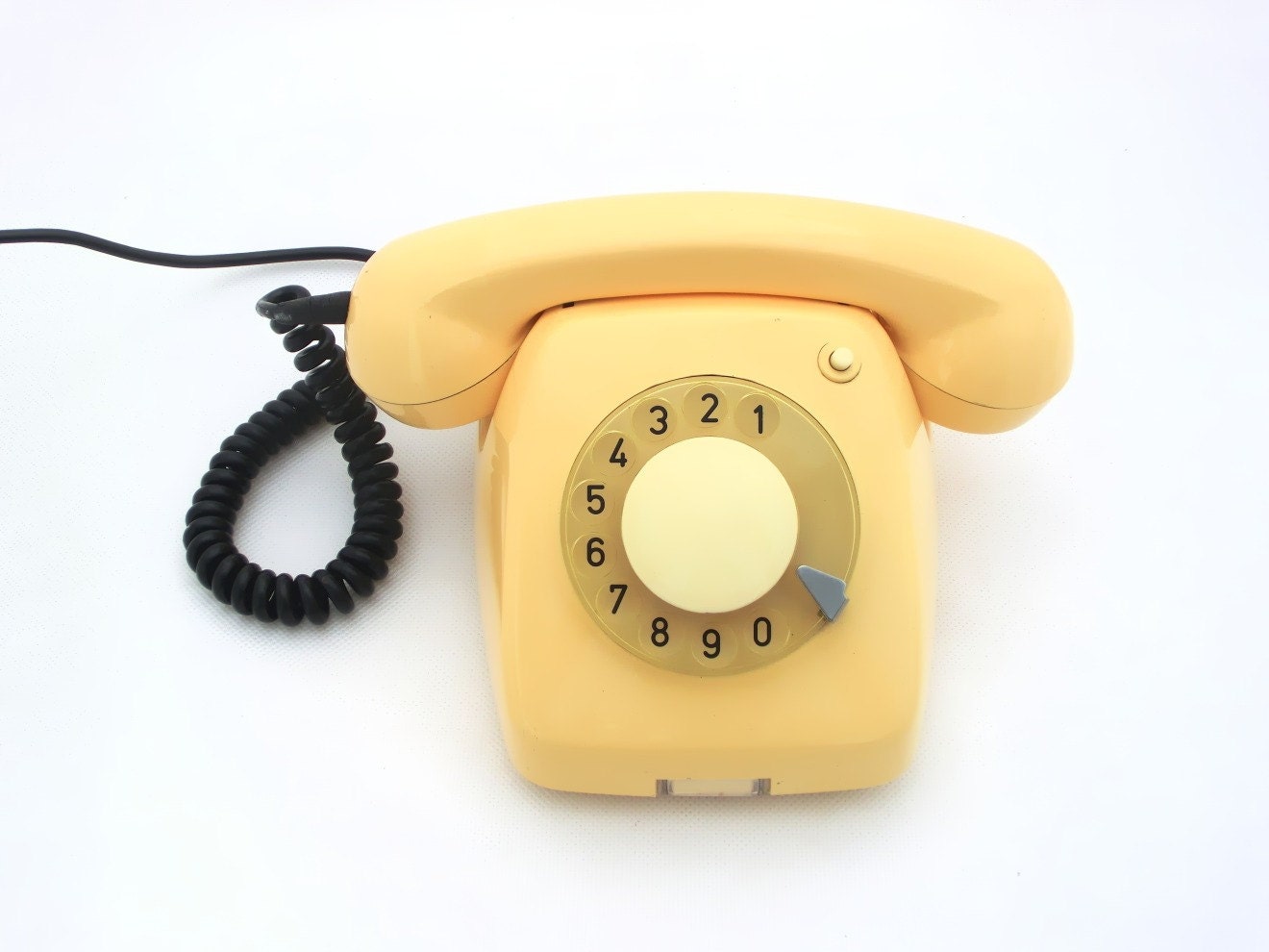 Vintage creamy yellow rotary telephone