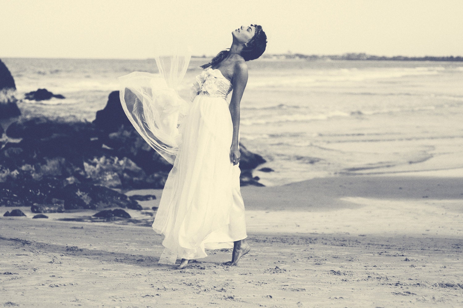 Strapless lace wedding dress with handmade flowers and layers of soft chiffon throughout the skirt