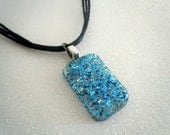 Blue glitter charm -- black cord necklace