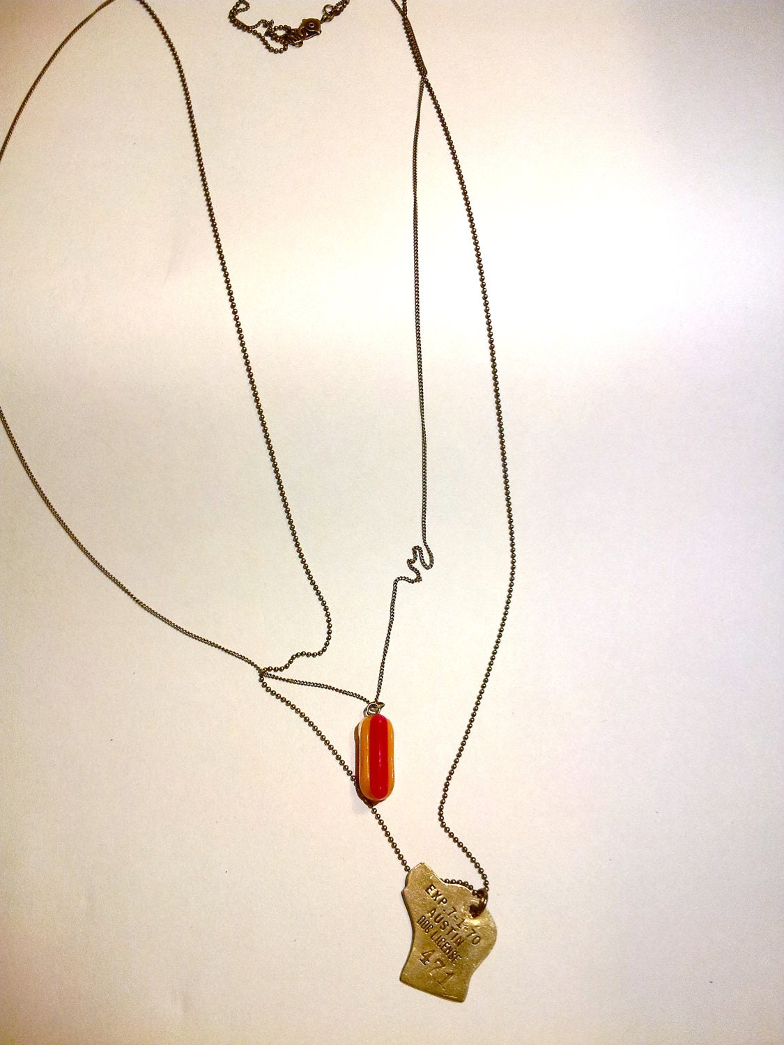 Extra-long double strand necklace featuring antique dog tag from Austin, TX, and lucite hotdog charm.  That's hot. (Dog)