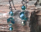 Peacock green ab swarovski crystal dangle earring with tibetan silver daisy spacers and gun metals findings