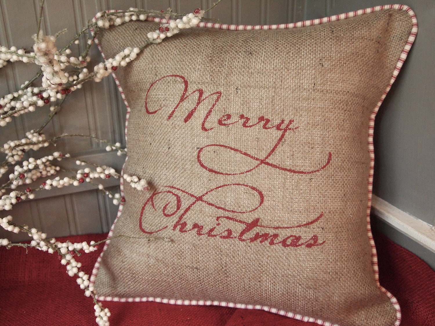 Merry Christmas hand painted in red on natural  burlap pillow cover with red and white french ticking, piping