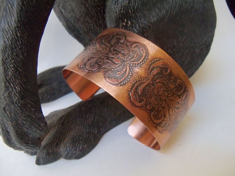 Copper cuff bracelet created from sheet metal and etched with a floral design