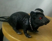 Sparkly black rat wearing a top hat.