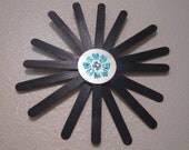 Black Sun with Blue Flower