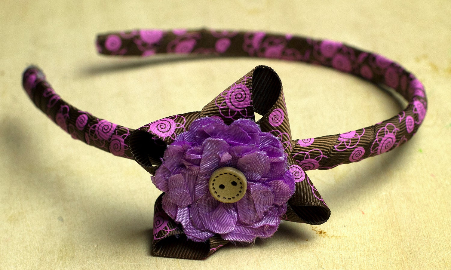 Chocolate And Lavender Colored Butterfly Wing Ribbon Creation With a Lavender Flower And Button Accent.  Girls And Toddlers