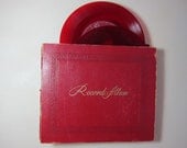 Record album, pair of red records and ten other 45s for lovers of vintage 1940s and 1950s music on vinyl