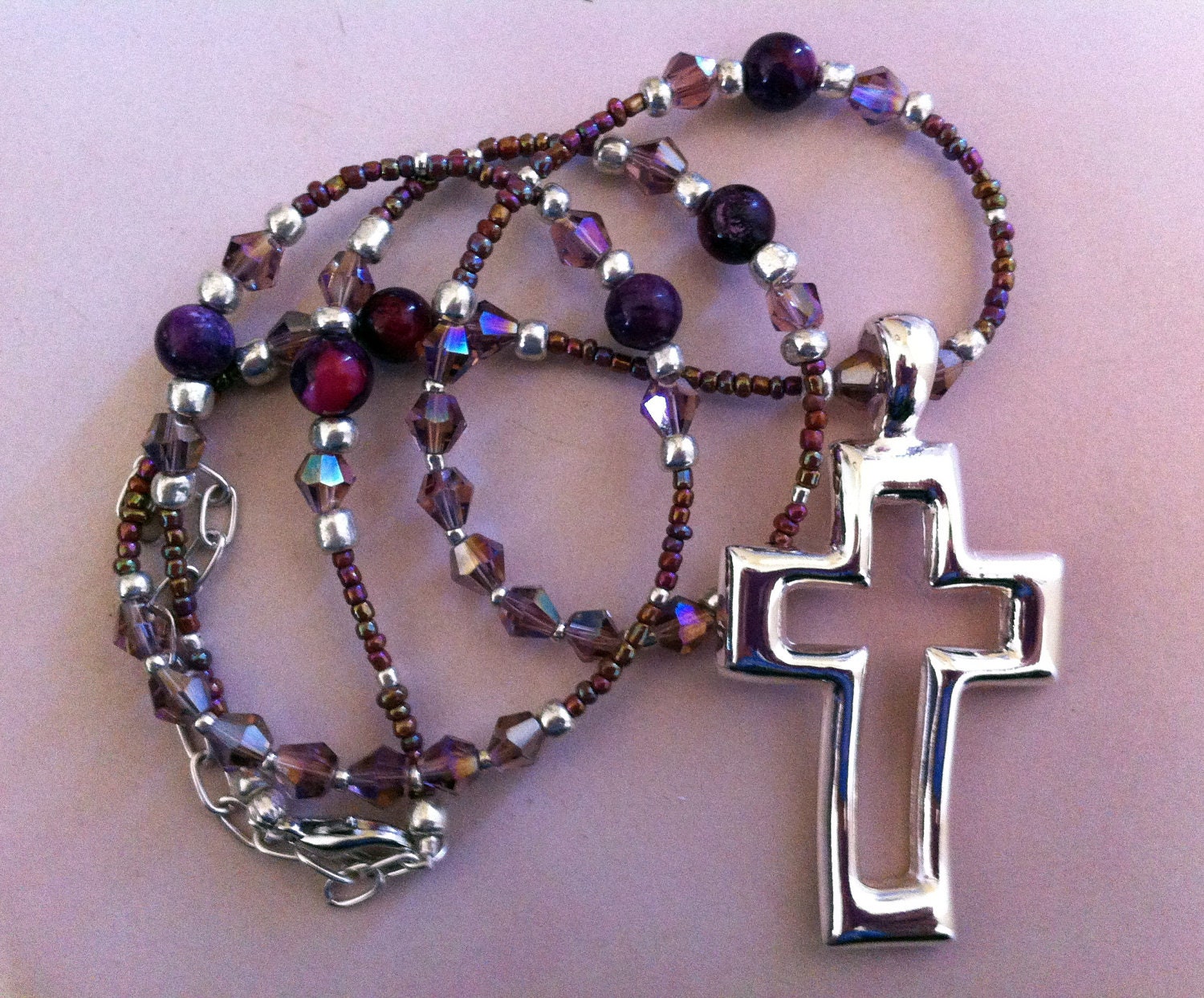 Hand beaded necklace w/beautiful silver toned cross - made with crystal, glass and shell amethyst beads.