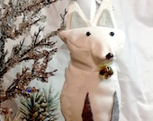 Small arctic white fox ornament with a Christmas bell