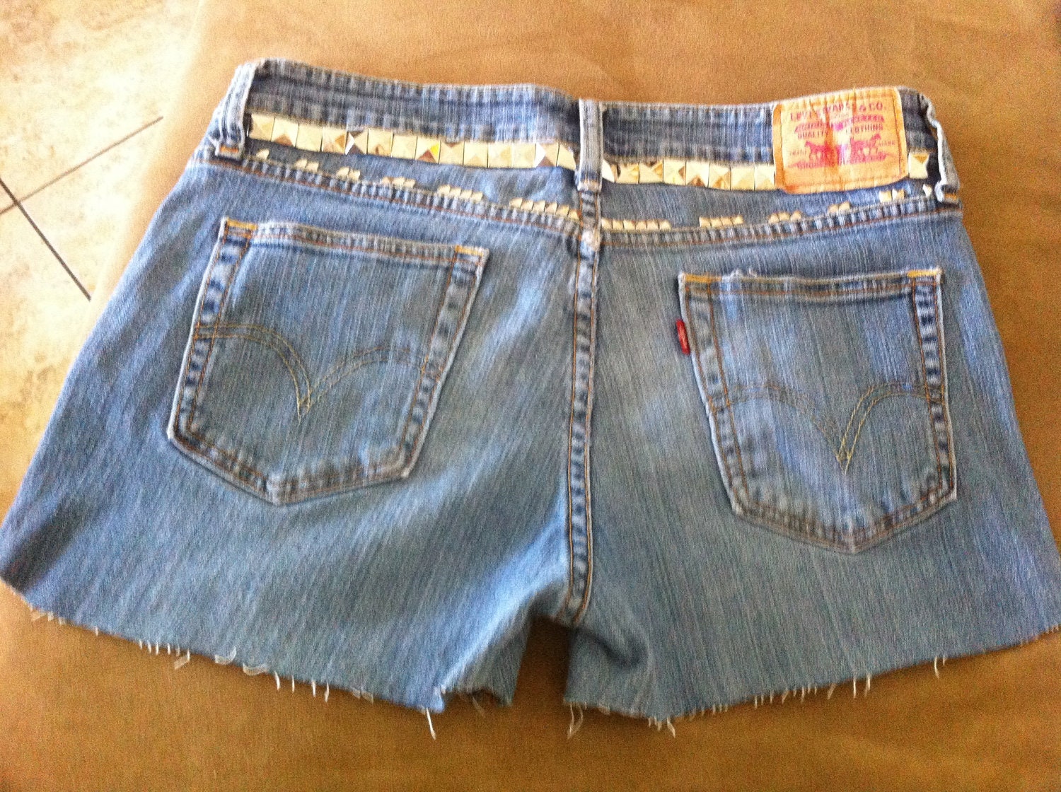 STUDDED and SPIKED Distressed Mid to High Waisted Faded Blue Denim Jean Shorts with Orange Stitching Pink Levis Patch Font Size 9S