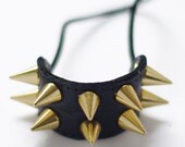 Handmade black leather hair elastic with golden or silver mini cone spikes.