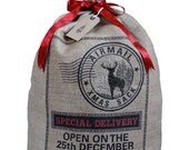 Hessian Christmas sack, reindeer silhouette stocking with red ribbon tie and gift tag