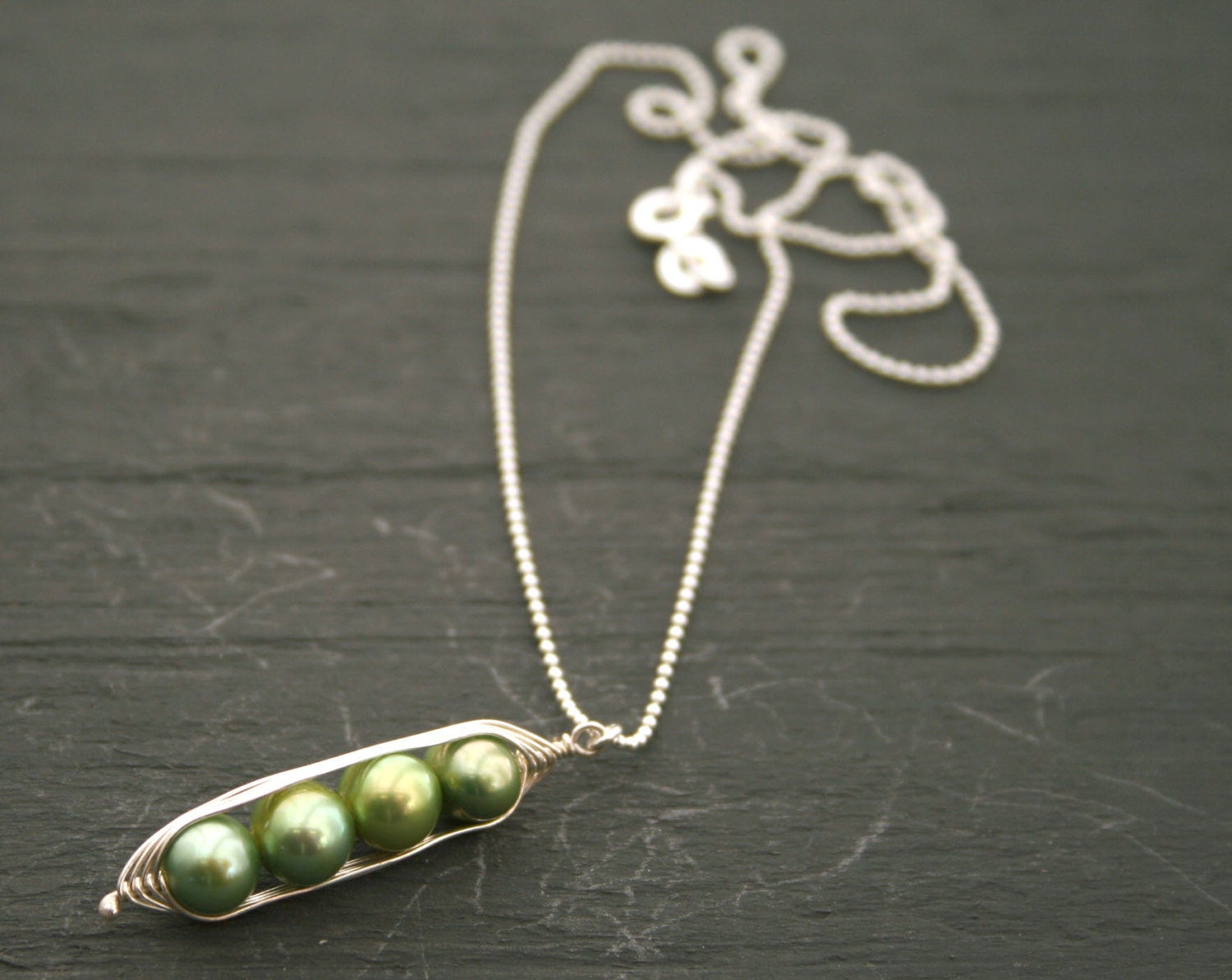 Peapod necklace. Four peas in a pod, green pearl pendant on sterling silver chain.