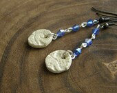 White Lace. Lace patterned ceramic bead with blue crystals.