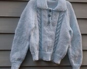 Girl, size 3/4, Tab front cable sweater in pale blue.