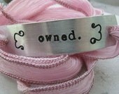 Owned Silk Ribbon Wrap Bracelet, aluminum tag with hand dyed ribbon in shades of pale pink