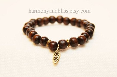 Gold feather charm wood stretch beaded bracelet
